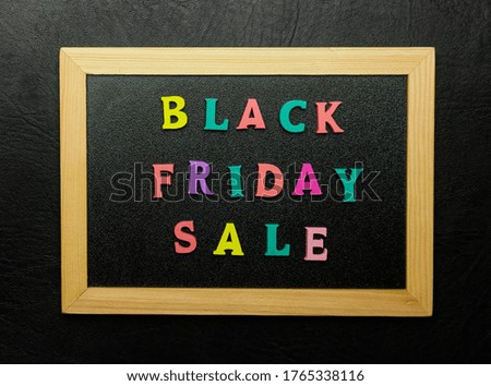 Black friday sale sign made with wooden letters on blackboard over black background