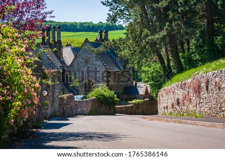 Old stone cottages and trees along the road. Countryside landscape of small village Ashford-in-the-Water in Derbyshire Peak District, England. Royalty-Free Stock Photo #1765386146