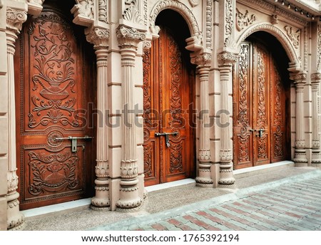 Large wooden Temple doors in Gujarat, India.  Royalty-Free Stock Photo #1765392194