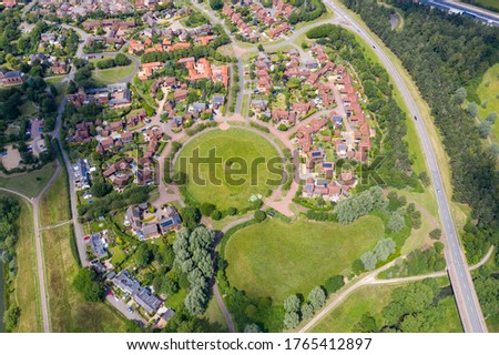 Aerial photo of the village of Milton Keynes in the UK showing a typical British housing estate on a sunny summers day taken with  a drone from above Royalty-Free Stock Photo #1765412897