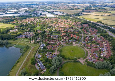 Aerial photo of the village of Milton Keynes in the UK showing a typical British housing estate on a sunny summers day taken with  a drone from above Royalty-Free Stock Photo #1765412900