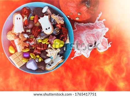 Halloween Jack o Lantern candy bowl with candy and halloween cookies Trick or Treat sweets - holiday card