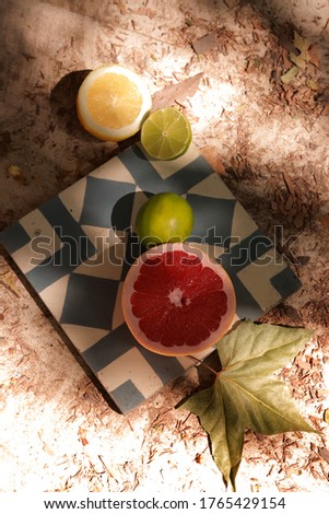 flat lay on a retro tile with grapefruits and limes