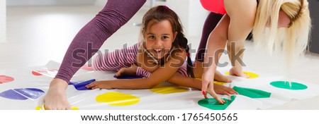 little girl plays twister at home