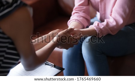 African psychologist hold hands of girl patient, close up. Teenage overcome break up, unrequited love. Abortion decision. Psychological therapy, survive personal crisis, individual counselling concept Royalty-Free Stock Photo #1765469660