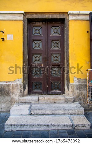 Old brown wooden front door. Classic retro doors in a european city. High quality photo. 