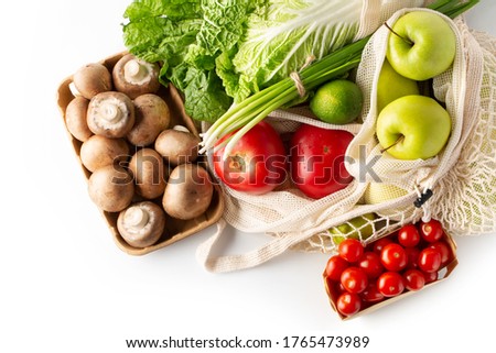 Plastic free. Healthy food. Fresh vegetables and fruits in eco-friendly reusable cotton bags on white background. Top view.