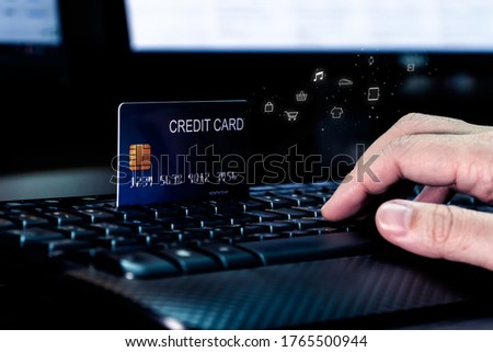 Hand with Credit card on keyboard and shopping icon . Concept for technology and e-commerce.