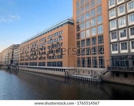 Stunning view of a canal with water and facades of architecture buildings in Hamburg downtown, urban landscape of Hamburg city