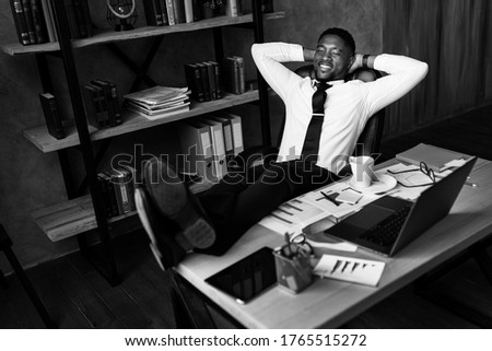 Handsome african business man relax after work in modern office