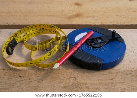 construction pencil and construction measuring tape on the background of wooden boards. The concept of building wooden frame houses. copy space.