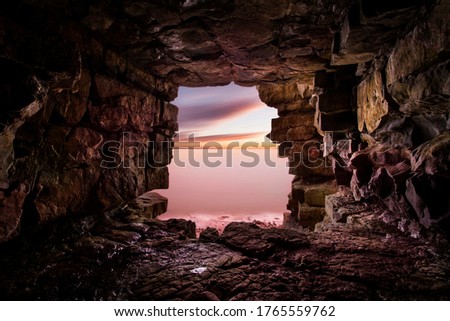 View of the ocean from inside a cave. Perspective photo using the cave opening as a window.