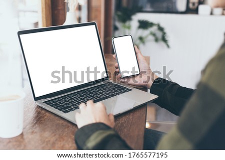 computer,cell phone mockup image.hand woman work using laptop texting mobile.blank screen with white background for advertising,contact business search information on desk in cafe.marketing,design