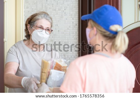 Delivering food to senior woman during quarantine Coronavirus (Covid-19) epidemic Royalty-Free Stock Photo #1765578356