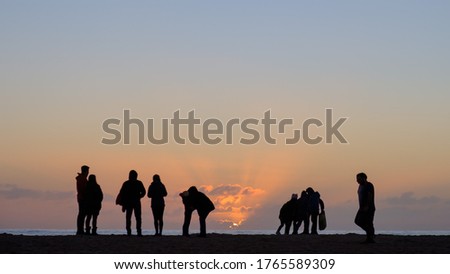 Family enjoying sunset over the Pacific ocean