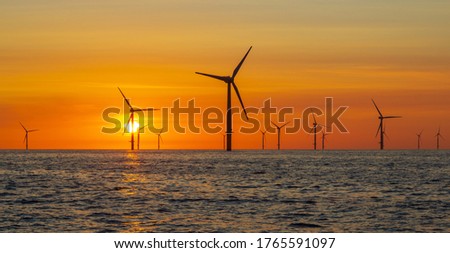 Beautiful sunset in the North Sea offshore wind farm Royalty-Free Stock Photo #1765591097