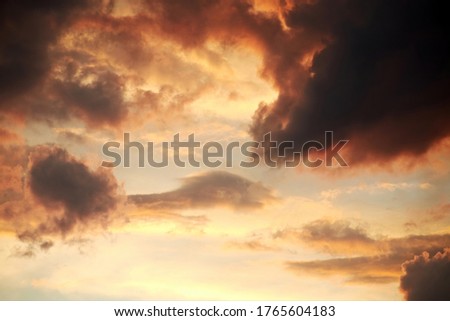 Dramatic twilight sky with clouds. Colorful cloudscape and atmosphere. Vivid sunset lights in the sky