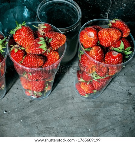two glasses with fresh red ripe strawberries