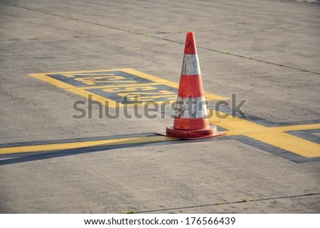 Traffic cone on the airport runway in Ruzyne, Czech republic.