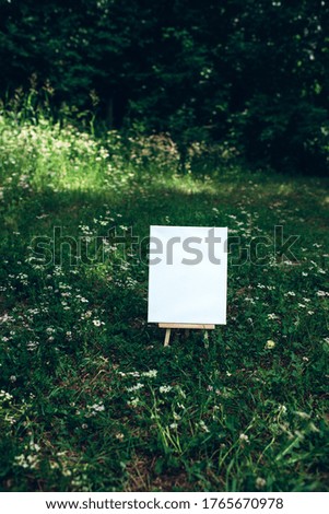 White empty mockup template poster canvas painting on green leaves background