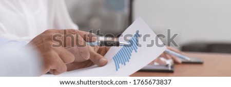 Close up hand point graph and talk job in business meeting.