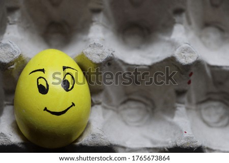 Egg with happy face in the tray