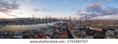 Panoramic Aerial drone shot of Hungarian Parliament Kossuth Square by Danube river in Budapest sunset Royalty-Free Stock Photo #1765683767