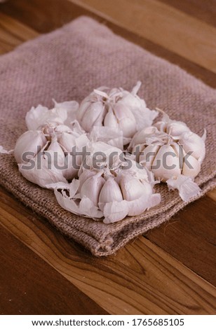 garlic and burlap cloth on a wooden table