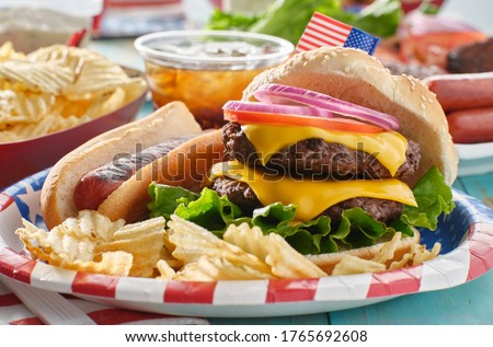 4th of july themed burger and hot dog meal on paper plate