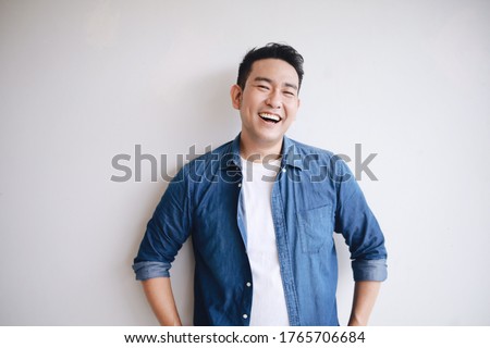 Portrait of handsome man in blue shirt with smiling face.