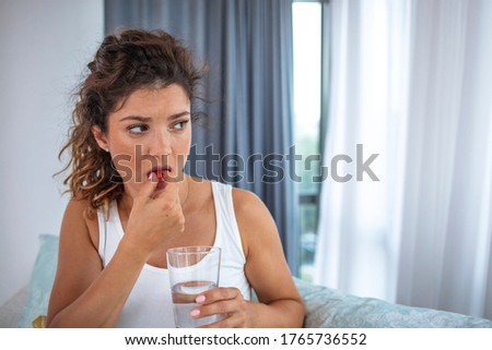 Diet. Nutrition. Healthy Eating, Lifestyle. Close Up Of  Woman Taking Pill With Cod Liver Oil Omega-3 And Holding A Glass Of Fresh Water In Morning. Vitamin D, E, A Fish Oil Capsules.