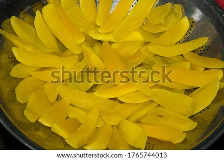 Close up of boiled fresh mango slices in a bowl.Fresh yellow mango slices.
