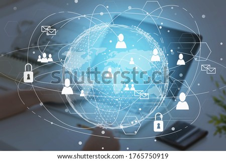Businesswoman using laptop in blurry office with double exposure of global social network interface. Concept of HR. Toned image. Elements of this image furnished by NASA