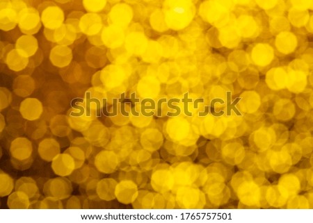 Glitter festive christmas lights background. light and gold de focused texture