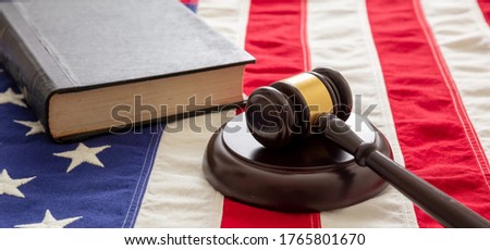 Law case closed. Judge gavel and book on US of America flag background. Justice in USA concept