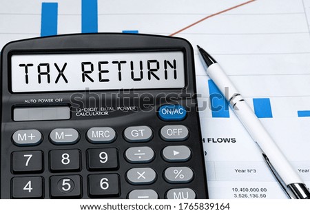 Word TAX RETURN on calculator. Business and tax concept. Stock photo