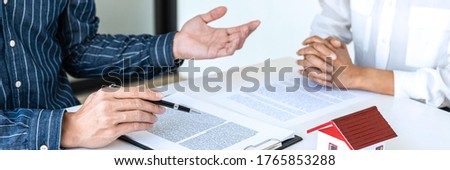 Real estate broker agent being analysis and making the decision a home estate loan to customer to signing contract documents for realty purchase, Bank employees recommend mortgage loan approval.