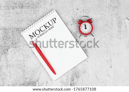 mockup of white notebook and red watch on marble background