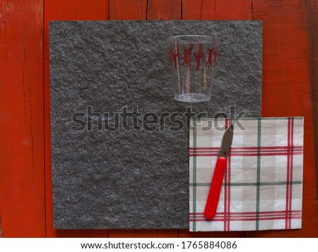 Lovely flat lay image of crayfish party celebration with the knife with a hole and rustic red background. Copy space.