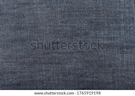 Dark blue denim fabric background. Close up