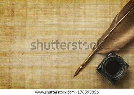 Old  Papyrus Paper and Feather Quill with Glass Ink Bottle and Copy Space. Royalty-Free Stock Photo #176593856