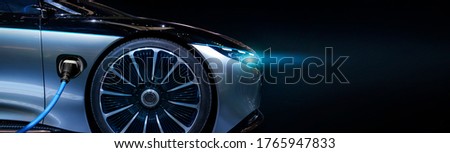 Luxury car electric car is charging. Close-up.  Royalty-Free Stock Photo #1765947833