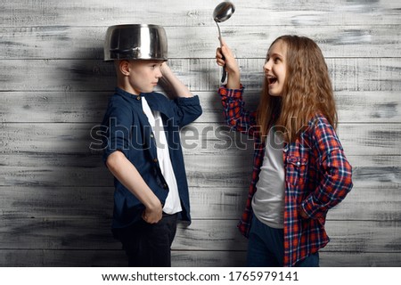 Kids with pot on head and ladle in hand