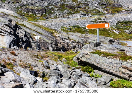 Mountain road with road signs on the way to Stranda, Norway in the summer.