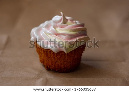 Vanilla cupcakes with protein cream on a beige background