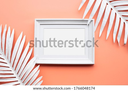 Picture frame with white tropical leaf.background design decoration.flat lay
