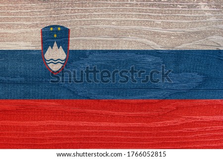 The Slovenian flag with a tree structure. Flag of Slovenia on a wooden texture