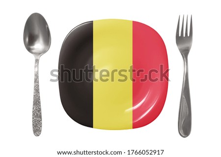 Plate with the Belgian flag. An empty plate with a spoon and fork on a white background. Isolated image