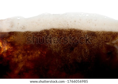 Cola soda bubble foam with ice in glass on white background 