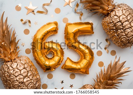 65th birthday celebration card with gold foil balloons and golden pineapples